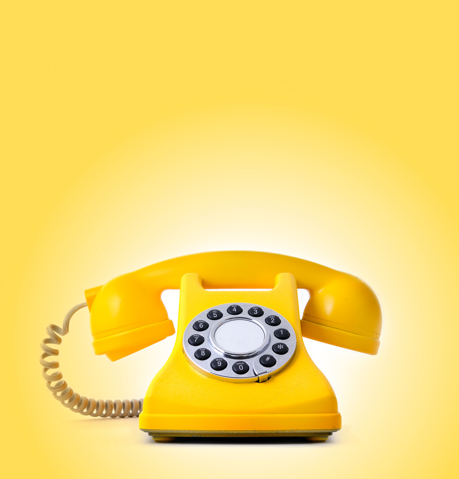 yellow painted classical phone with bright background